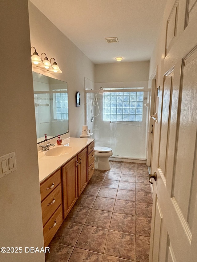 47 Elder Dr, Palm Coast, FL 32164 - full bath featuring a stall shower, vanity, toilet, and tile patterned flooring
