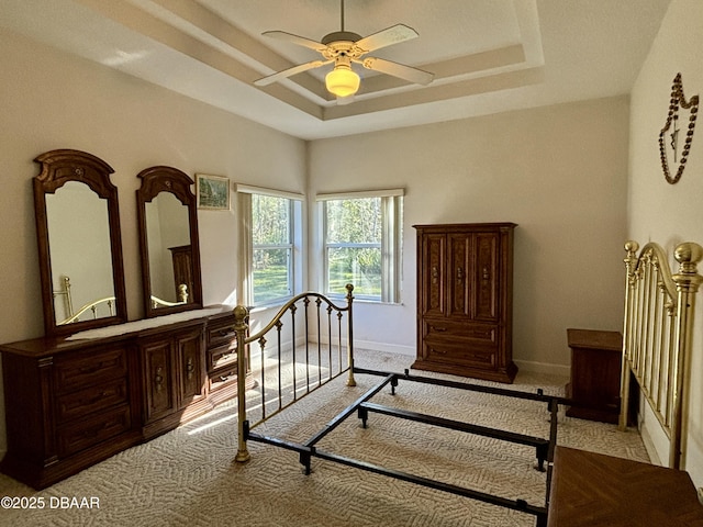 47 Elder Dr, Palm Coast, FL 32164 - bedroom featuring a tray ceiling, carpet, baseboards, and a ceiling fan
