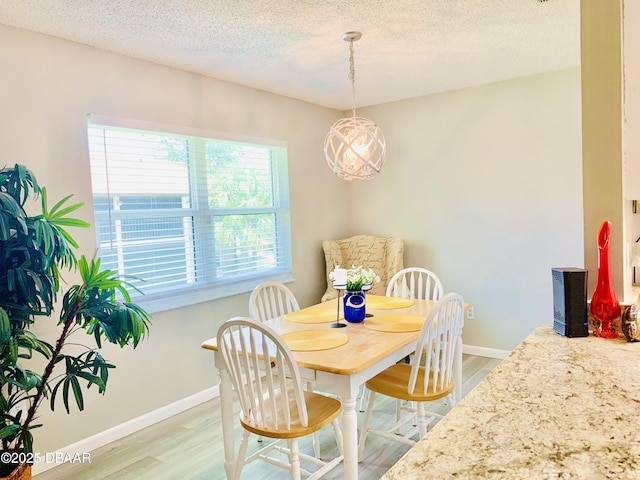415 Banana Cay Dr Unit J, South Daytona, FL 32119 - dining area featuring light wood-style floors and a textured ceiling