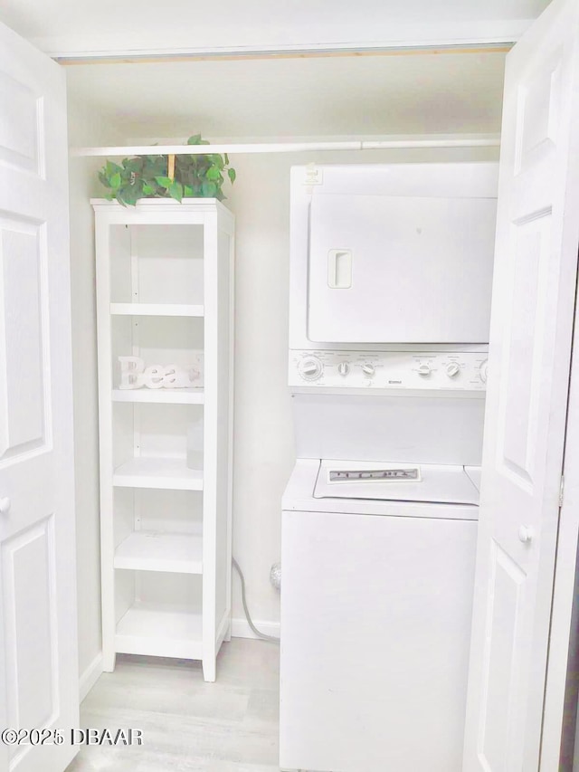 415 Banana Cay Dr Unit J, South Daytona, FL 32119 - laundry area with estacked washer and dryer and light wood-type flooring