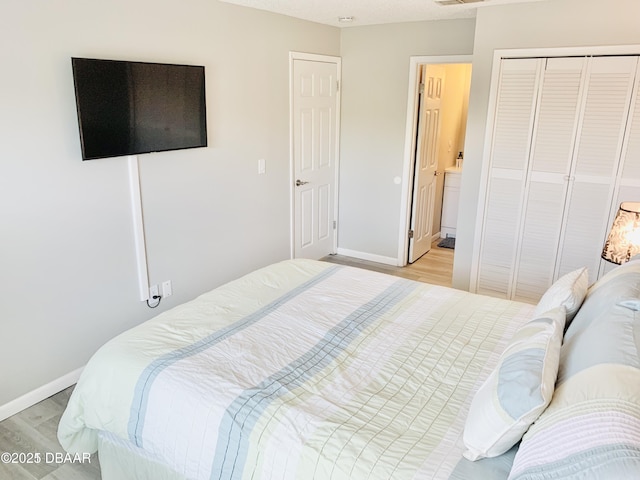 415 Banana Cay Dr Unit J, South Daytona, FL 32119 - bedroom with light wood-style floors and a closet