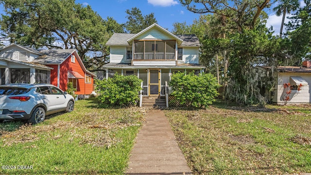 view of front of house with a sunroom