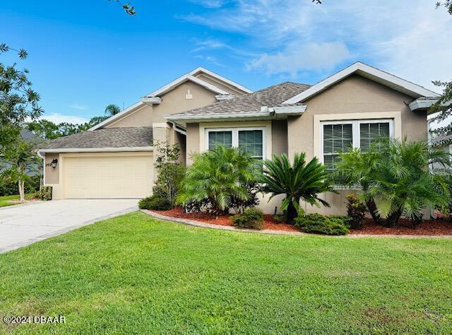 single story home with a front yard and a garage