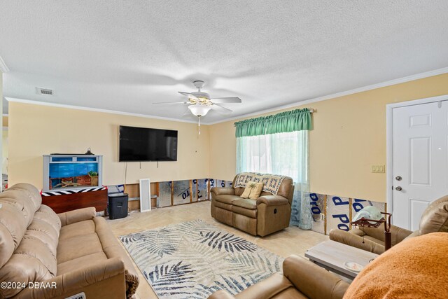 living room featuring a textured ceiling, ceiling fan, and crown molding