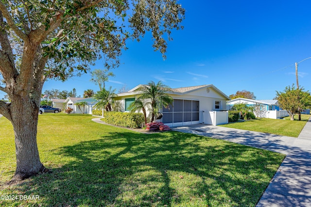 ranch-style home with a front lawn and a garage