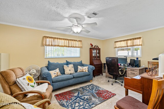 office with a textured ceiling, ceiling fan, ornamental molding, and light carpet