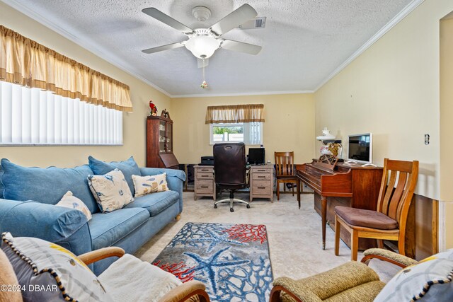 home office featuring ceiling fan, crown molding, light colored carpet, and a textured ceiling