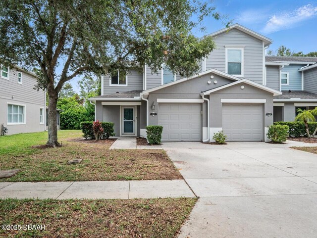 567 Mount Olympus Blvd, New Smyrna Beach, FL 32168 - view of front facade featuring driveway, an attached garage, and stucco siding