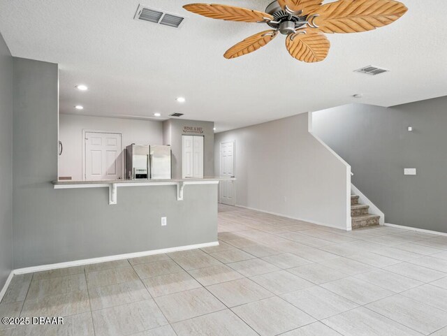 567 Mount Olympus Blvd, New Smyrna Beach, FL 32168 - unfurnished living room with ceiling fan, stairs, baseboards, recessed lighting, and light tile patterned floors