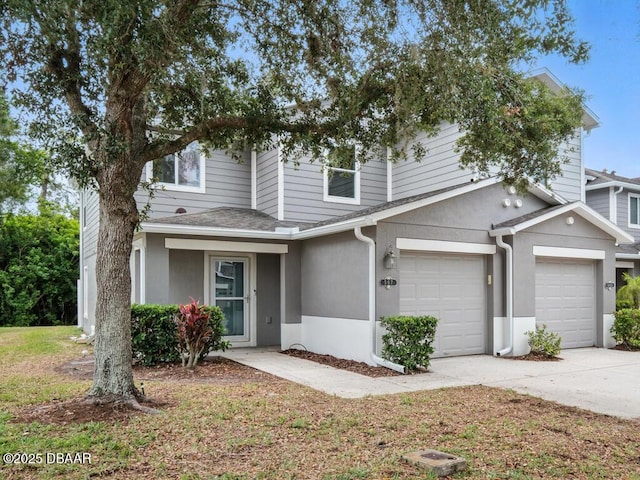 567 Mount Olympus Blvd, New Smyrna Beach, FL 32168 - view of front facade featuring driveway, an attached garage, a shingled roof, and stucco siding