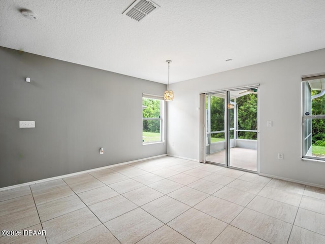 567 Mount Olympus Blvd, New Smyrna Beach, FL 32168 - tiled empty room with healthy amount of natural light, a smoke detector, baseboards, and a textured ceiling