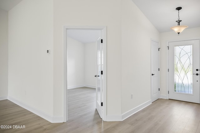111 Bird Of Paradise Dr, Palm Coast, FL 32137 - entrance foyer featuring light wood finished floors, vaulted ceiling, and baseboards