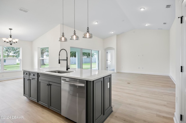 kitchen featuring an island with sink, sink, light hardwood / wood-style flooring, and dishwasher