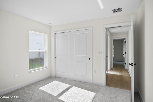 111 Bird Of Paradise Dr, Palm Coast, FL 32137 - unfurnished bedroom with carpet flooring, a closet, and baseboards