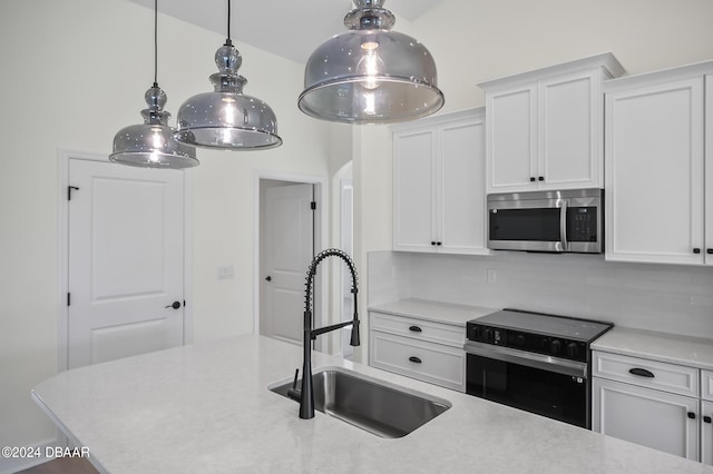 111 Bird Of Paradise Dr, Palm Coast, FL 32137 - kitchen featuring stainless steel microwave, electric range oven, a sink, light countertops, and white cabinetry