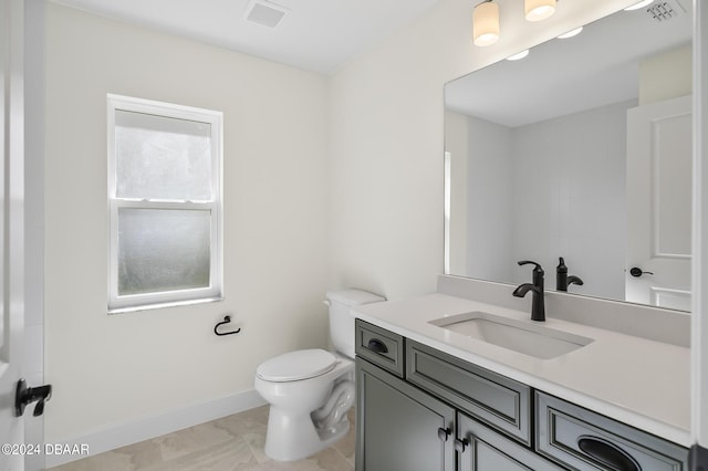 111 Bird Of Paradise Dr, Palm Coast, FL 32137 - bathroom with toilet, vanity, and baseboards