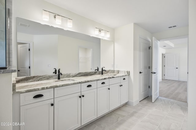 111 Bird Of Paradise Dr, Palm Coast, FL 32137 - bathroom with double vanity, a spacious closet, and baseboards