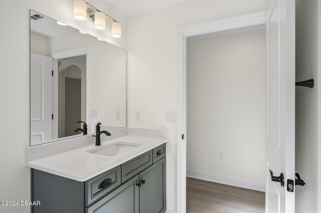 111 Bird Of Paradise Dr, Palm Coast, FL 32137 - bathroom featuring wood finished floors, vanity, and baseboards