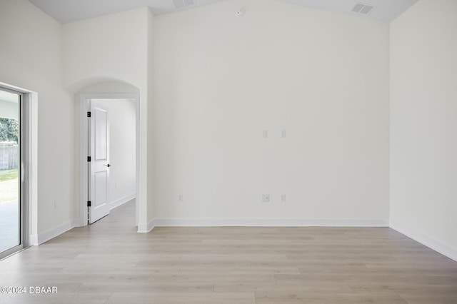 111 Bird Of Paradise Dr, Palm Coast, FL 32137 - spare room featuring light wood finished floors, baseboards, and vaulted ceiling