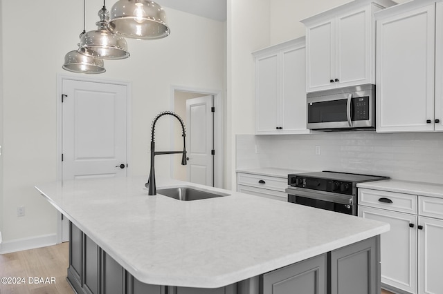 111 Bird Of Paradise Dr, Palm Coast, FL 32137 - kitchen with stainless steel microwave, range with electric cooktop, decorative backsplash, and light countertops