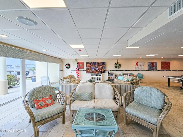 living room with a paneled ceiling