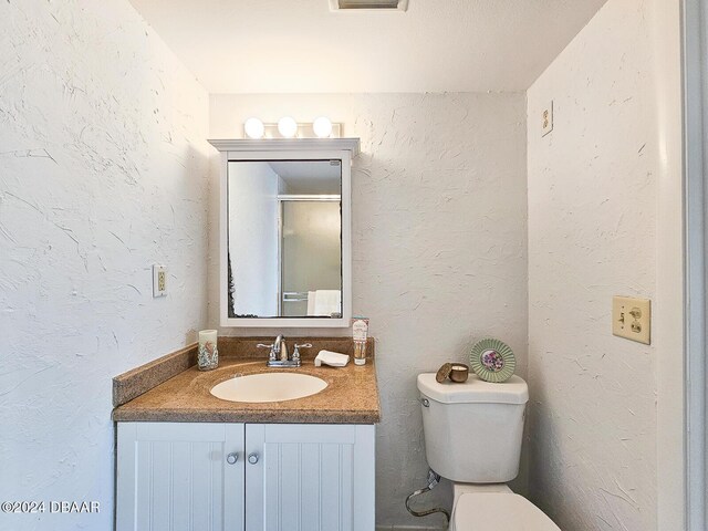3606 S Peninsula Dr # 404, Port Orange, FL 32127 - bathroom featuring vanity and a textured wall