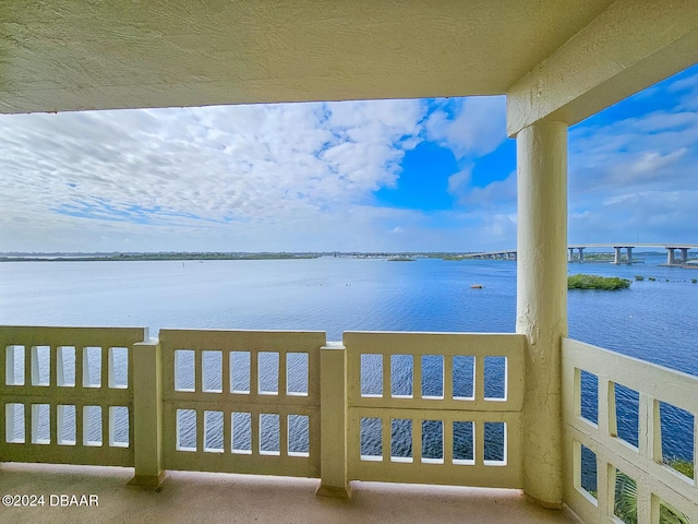 exterior space with a water view and a balcony