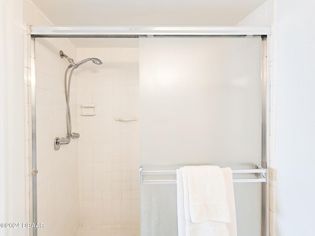 bathroom featuring a shower with door