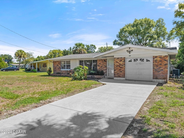 single story home with a garage and a front lawn