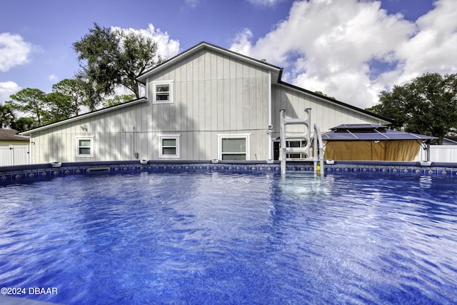 exterior space with a pool with hot tub