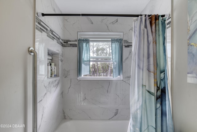 bathroom featuring shower / bathtub combination with curtain