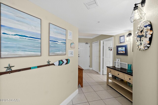 3145 S Atlantic Ave Unit 504, Daytona Beach Shores, FL 32118 - hallway with light tile patterned floors and baseboards