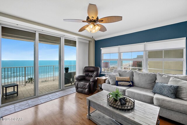 3145 S Atlantic Ave Unit 504, Daytona Beach Shores, FL 32118 - living room featuring a ceiling fan, wood finished floors, a water view, and crown molding