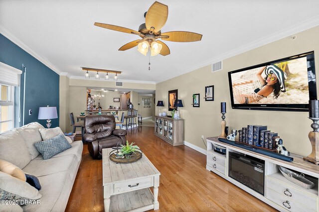 3145 S Atlantic Ave Unit 504, Daytona Beach Shores, FL 32118 - living room with crown molding, ceiling fan, light wood finished floors, and rail lighting