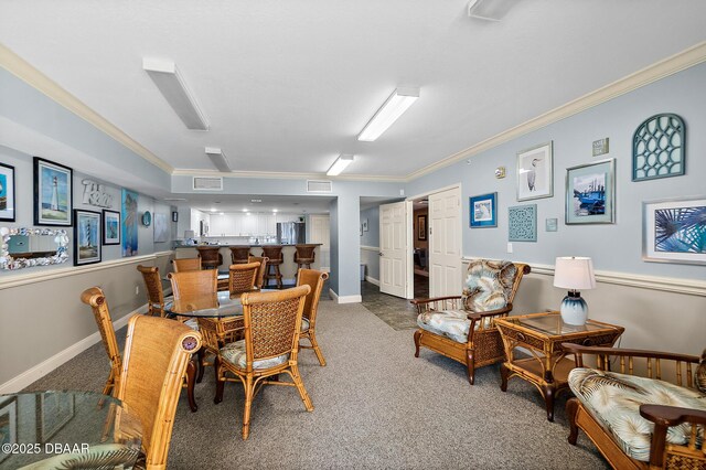 3145 S Atlantic Ave Unit 504, Daytona Beach Shores, FL 32118 - dining space with crown molding, carpet flooring, and a community bar