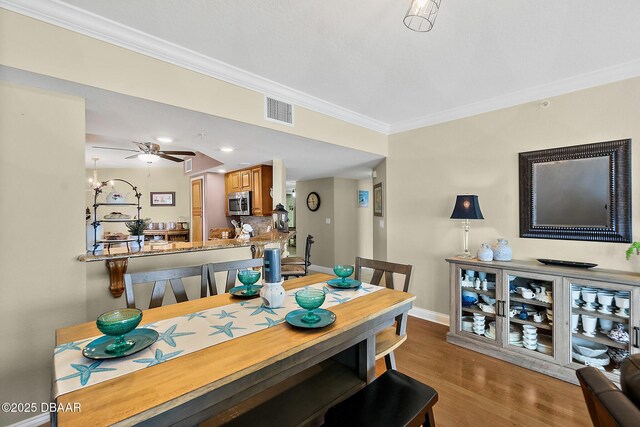 3145 S Atlantic Ave Unit 504, Daytona Beach Shores, FL 32118 - dining space with crown molding, wood finished floors, ceiling fan, and recessed lighting