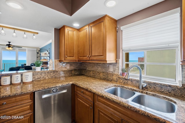 3145 S Atlantic Ave Unit 504, Daytona Beach Shores, FL 32118 - kitchen with dishwasher, ceiling fan, plenty of natural light, and dark stone counters