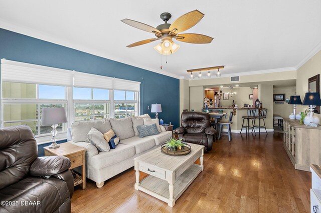 3145 S Atlantic Ave Unit 504, Daytona Beach Shores, FL 32118 - living area with a ceiling fan, ornamental molding, and wood finished floors