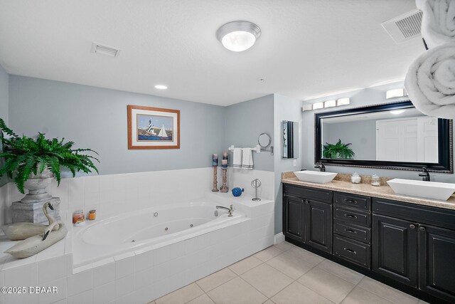 3145 S Atlantic Ave Unit 504, Daytona Beach Shores, FL 32118 - full bath featuring double vanity, a whirlpool tub, and tile patterned floors