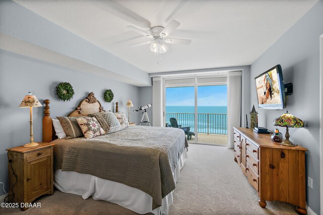 3145 S Atlantic Ave Unit 504, Daytona Beach Shores, FL 32118 - bedroom featuring access to exterior, light carpet, and a ceiling fan