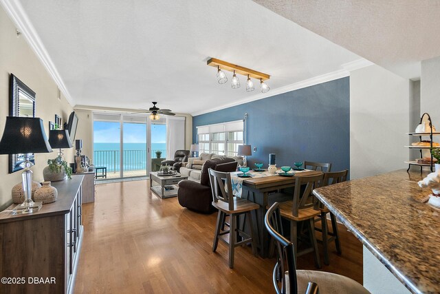 3145 S Atlantic Ave Unit 504, Daytona Beach Shores, FL 32118 - dining room with wood finished floors, ornamental molding, and a ceiling fan