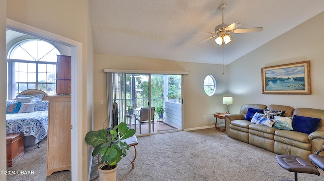 living room with a textured ceiling, vaulted ceiling, ceiling fan, and carpet