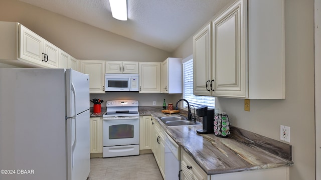 kitchen with vaulted ceiling, sink, white cabinets, and white appliances