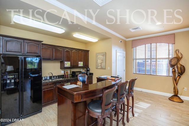 kitchen featuring black fridge with ice dispenser, sink, crown molding, dark brown cabinets, and light hardwood / wood-style flooring