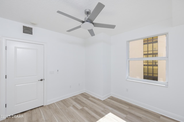 unfurnished room featuring ceiling fan, a textured ceiling, and light hardwood / wood-style flooring