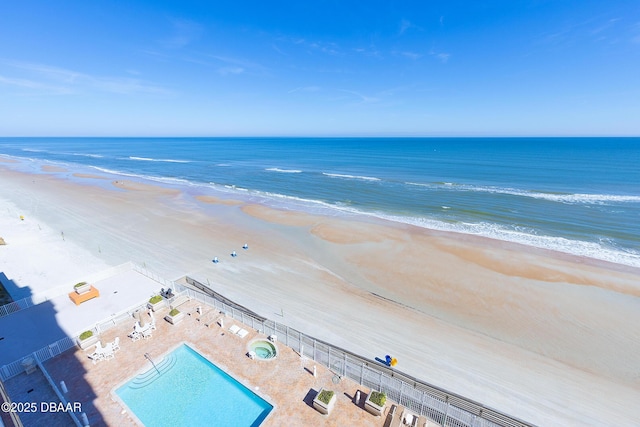 birds eye view of property with a view of the beach and a water view