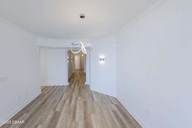 unfurnished dining area with crown molding, a notable chandelier, and light wood-type flooring