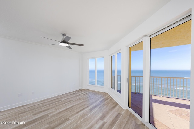 unfurnished room featuring a water view, ceiling fan, and light hardwood / wood-style flooring