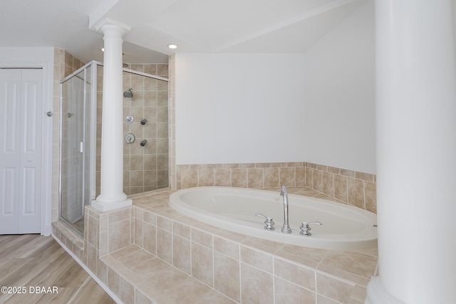 bathroom featuring hardwood / wood-style flooring, plus walk in shower, and ornate columns