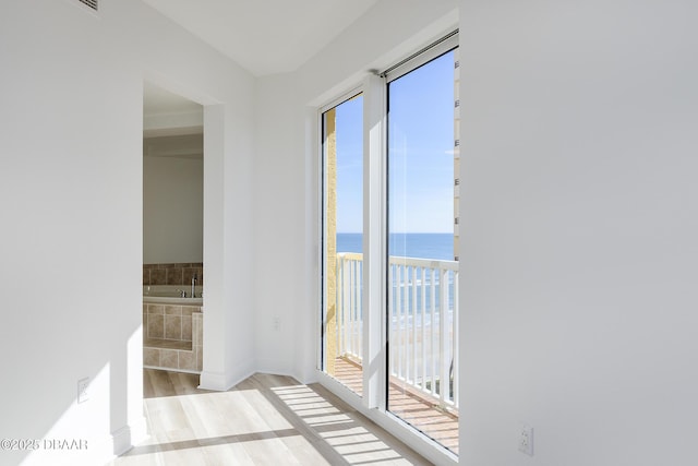 interior space featuring a water view and light hardwood / wood-style flooring